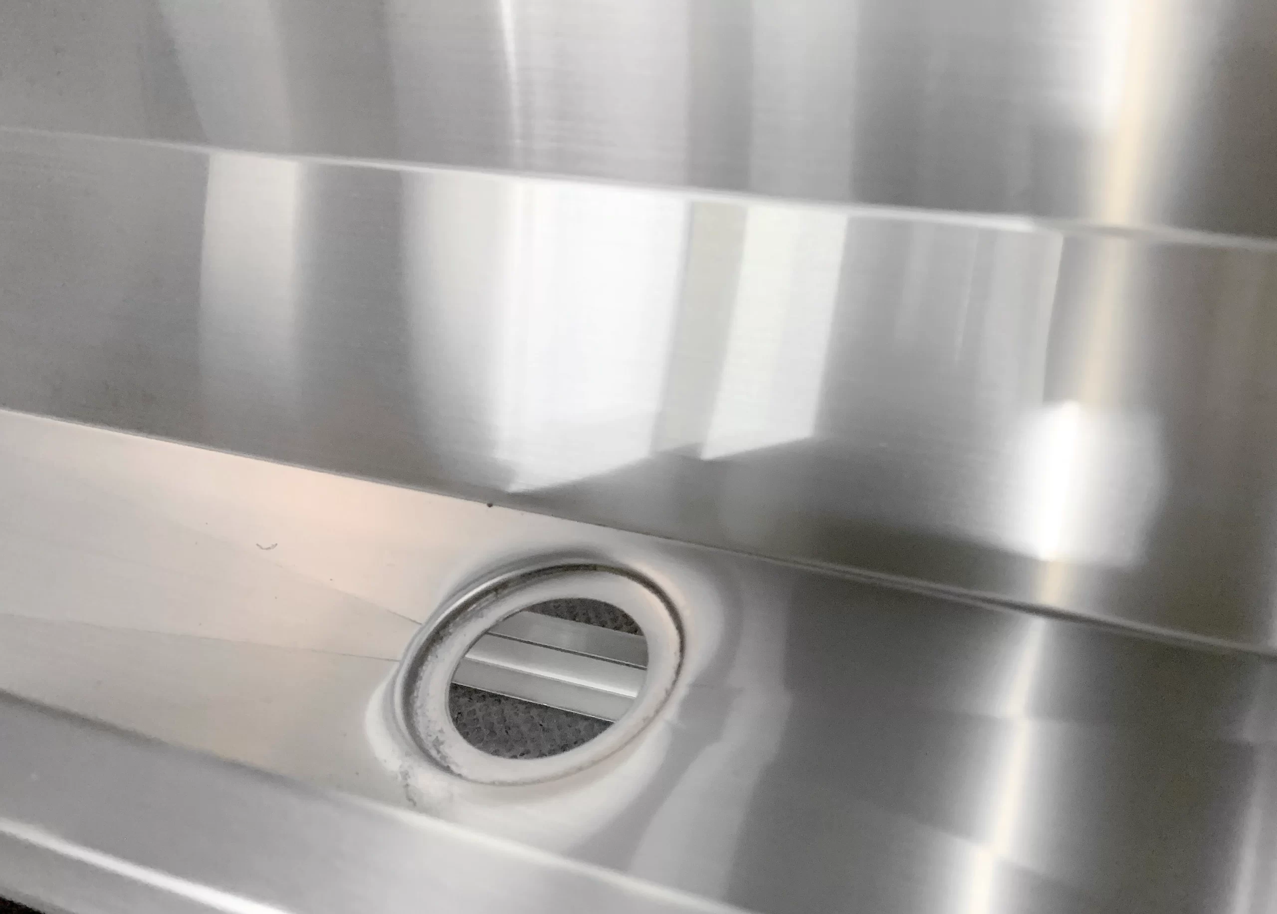 Urinal stainless steel drain closeup