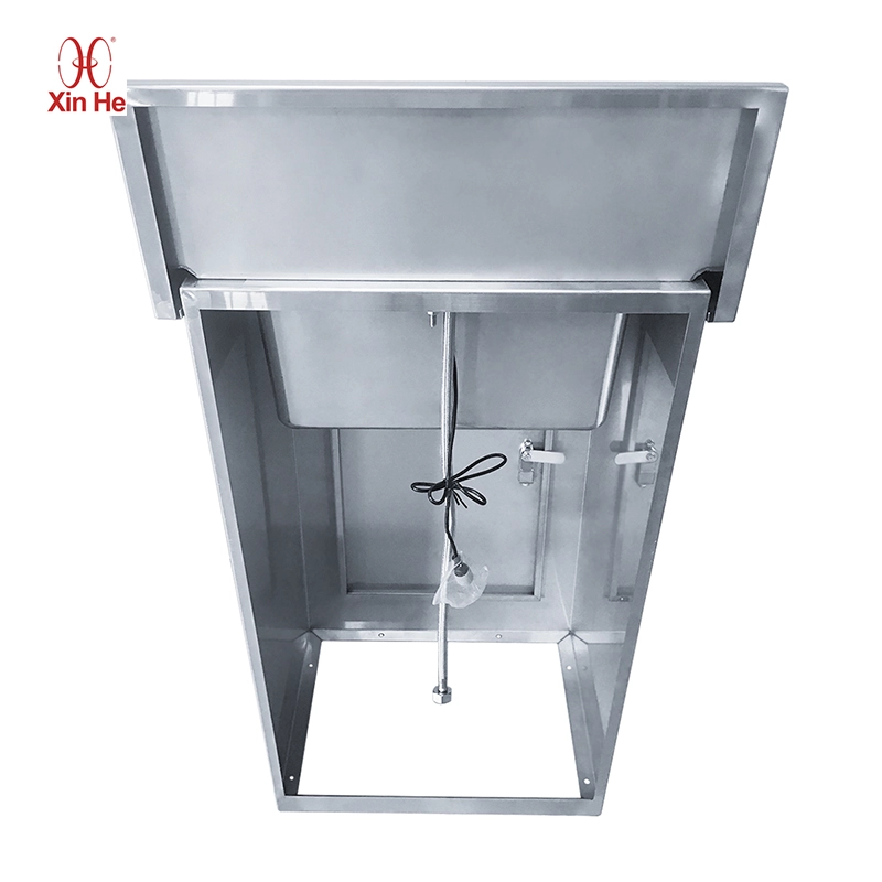 Stainless steel pedestal sink with interior plumbing access for easy maintenance of valves and sensor batteries.
